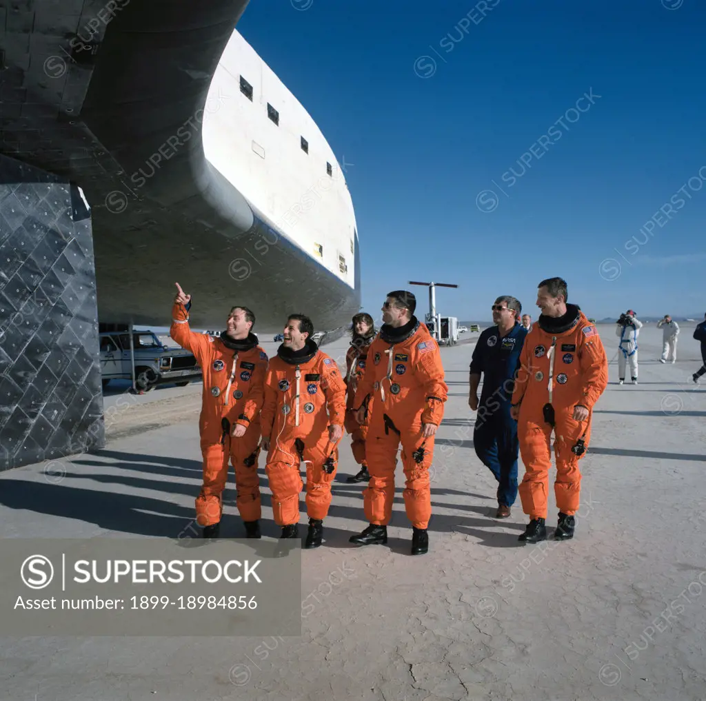 STS-37 crewmembers inspect the underside of Atlantis, OV-104, at EAFB. 