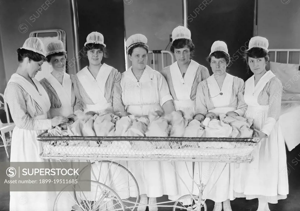 Nurses with babies in a hospital maternity ward ca. 1916-1919