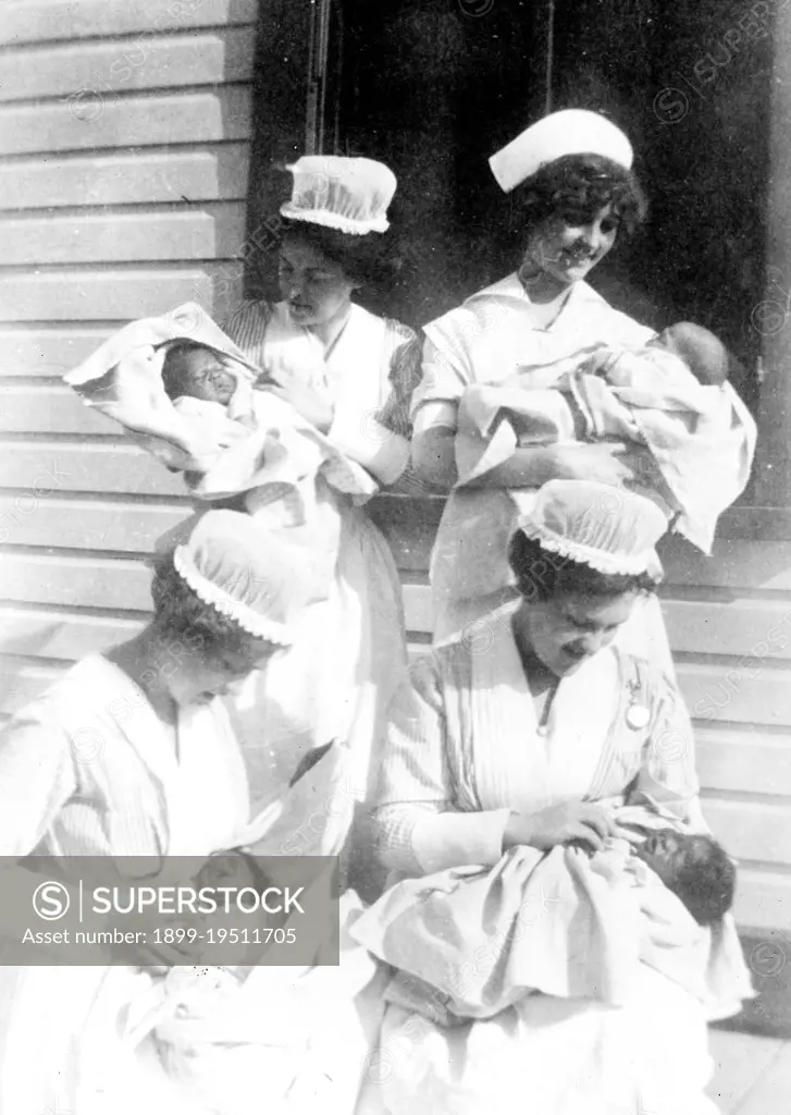 Nurses with babies outdoors ca. 1916-1919