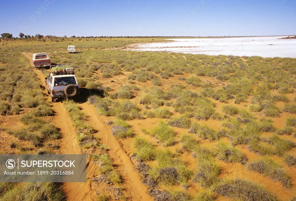 Four-wheel drive vehicles on the Canning Stock Route, Halls Creek to Wiluna through three deserts, the Great Sandy, the Gibson and the Little Sandy.  with a salt lake.  Western Australia