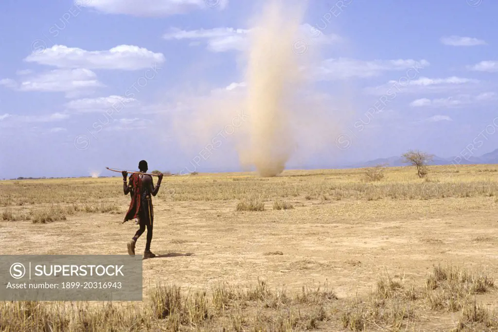 Dust devils,  occurring in deserts when the near-surface air heats up more than air further from the ground: warm air rises, cool air sinks and any disturbance from a gust of wind, a vehicle or even a running animal, causes the hotter air to rush up spinning in the descending column of cooler air.  Great Rift Valley, Kenya