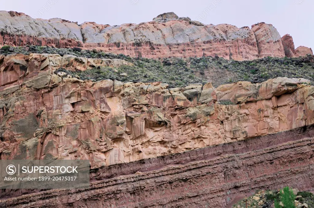 Multicolored sedimentary rock layers are evident in the colorful cliffs of Capitol Reef National Park, Geologic wonder. 