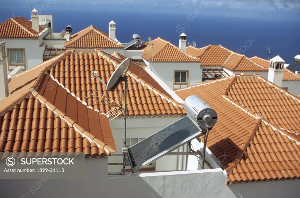 Solar panels on roof, Canary Islands. Solar panel, roof , house, South of La Palma. hot water. Village, roof line, terracotta, roof tiles, white washed walls, blue sky, renewable, sustainable, tourism, holiday, resort, responsible, energy,   