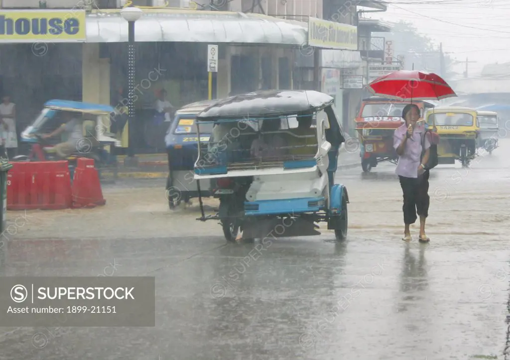 Monsoon rains, Philippines . The south west monsoon brings heavy rains to south east asia. Here Puerto Princesa City experiences heavy late July rains street awash with water.