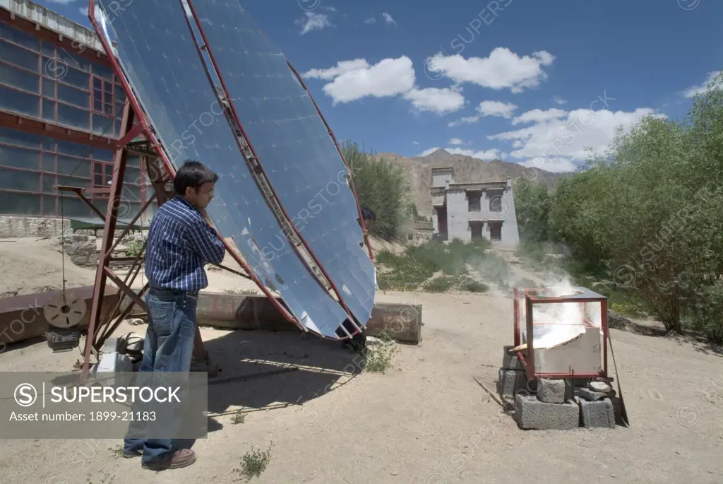 Demonstration of community solar cooker, ""scheffler"" cooker, heliostat (tracking movement of sun) - Leh, Ladakh, Himalayas., India. 