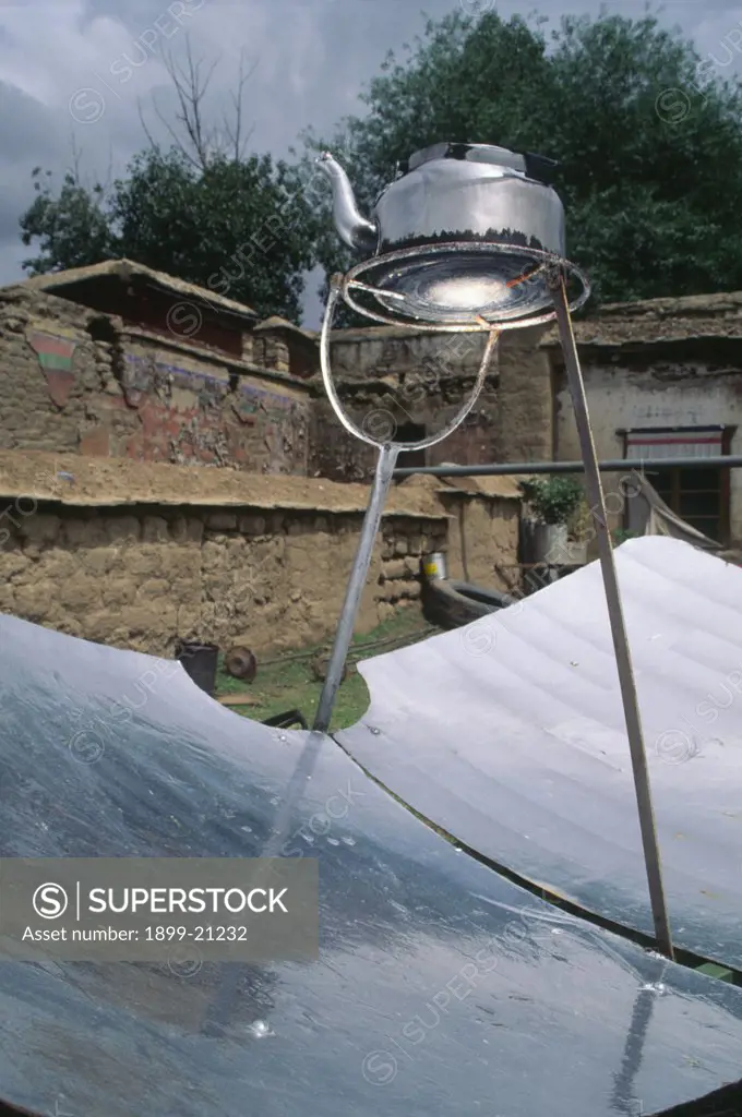 Solar powered kettle, Nepal. Solar powered kettle, the reflective sheets of metal reflect light on to the base of the kettle, heating the water inside.