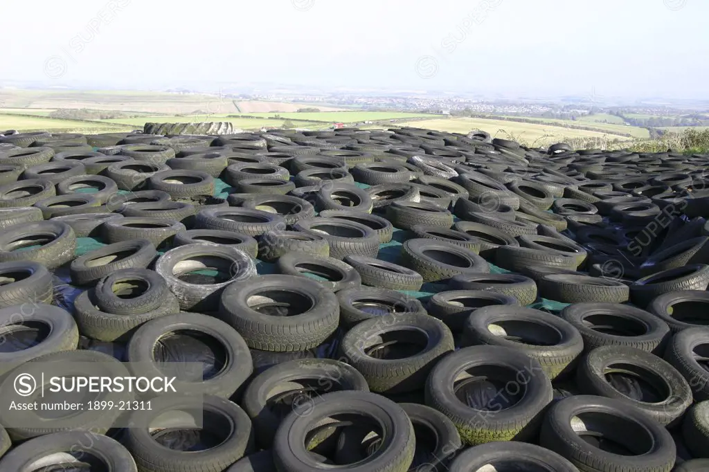 Sea of rubber tyres in Dorset, United Kingdom. Old tyres cover a silage clamp near Dorchester Dorset. View of countryside behind. 