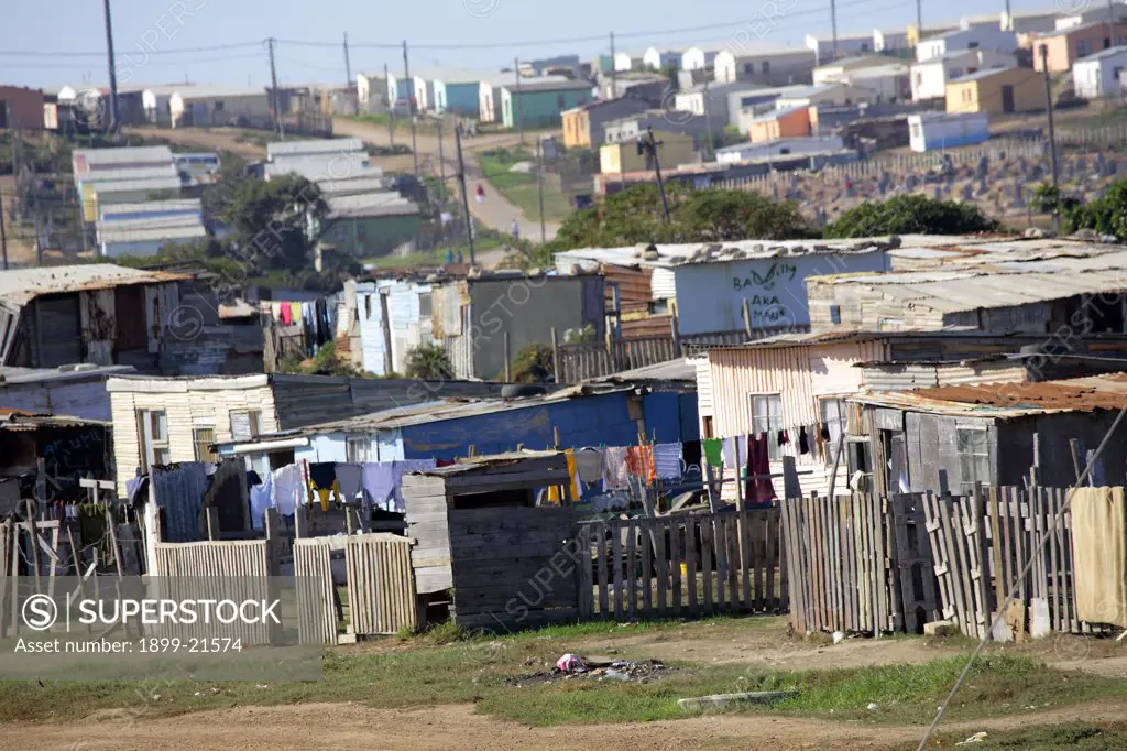 Shacks in foreground and new government housing in background, South Africa. Shacks in foreground and new government housing in background - No water and sewerage is erratic (bucket collection), Port Elizabeth.