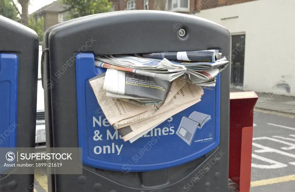 Stuffed Newspaper recycling bank - Turnham Green, London, England, UK. 