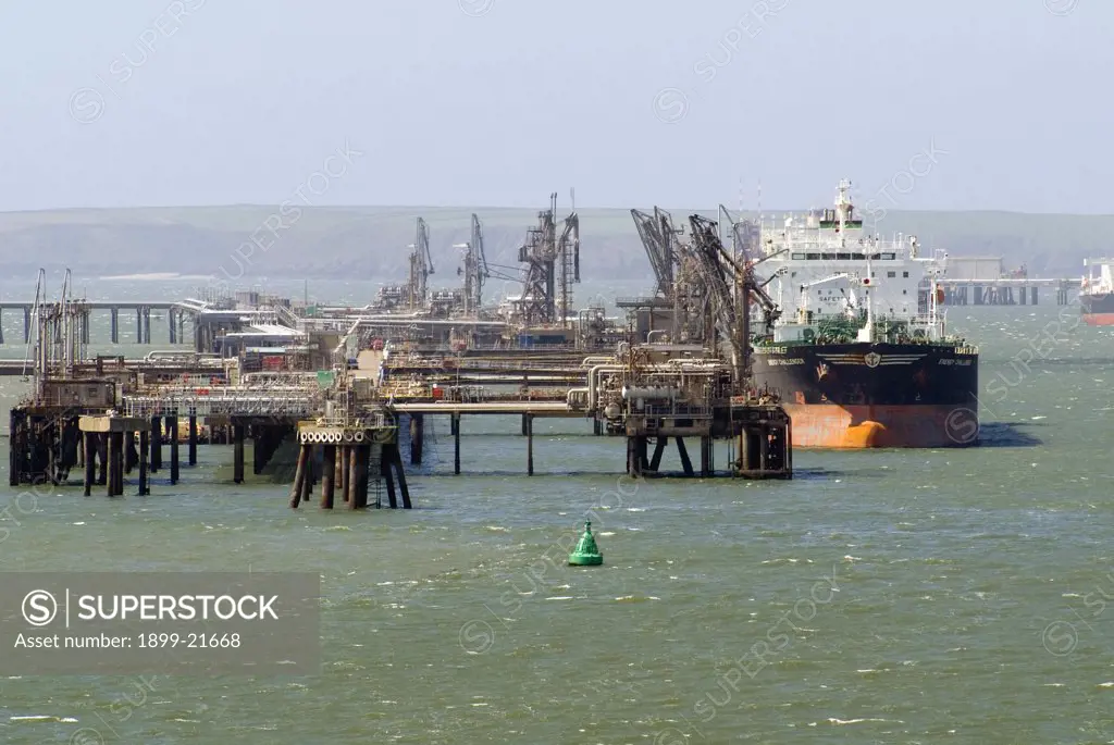 Energy Challenger', 74,000 DWT oil tanker, owned by Golden Energy Marine Corp., docked at Rhoscrowther Oil Refinery terminal, opp. Milford Haven south shore, Pembrokeshire, Wales, United Kingdom. DWT = Deadweight tonnage, the measure of how much weight a ship is or can carry.