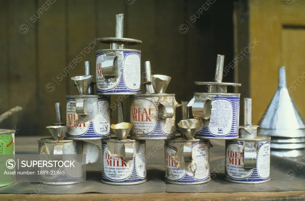 GHANA Tarkwa. Evaporated milk cans made into oil lamps..  