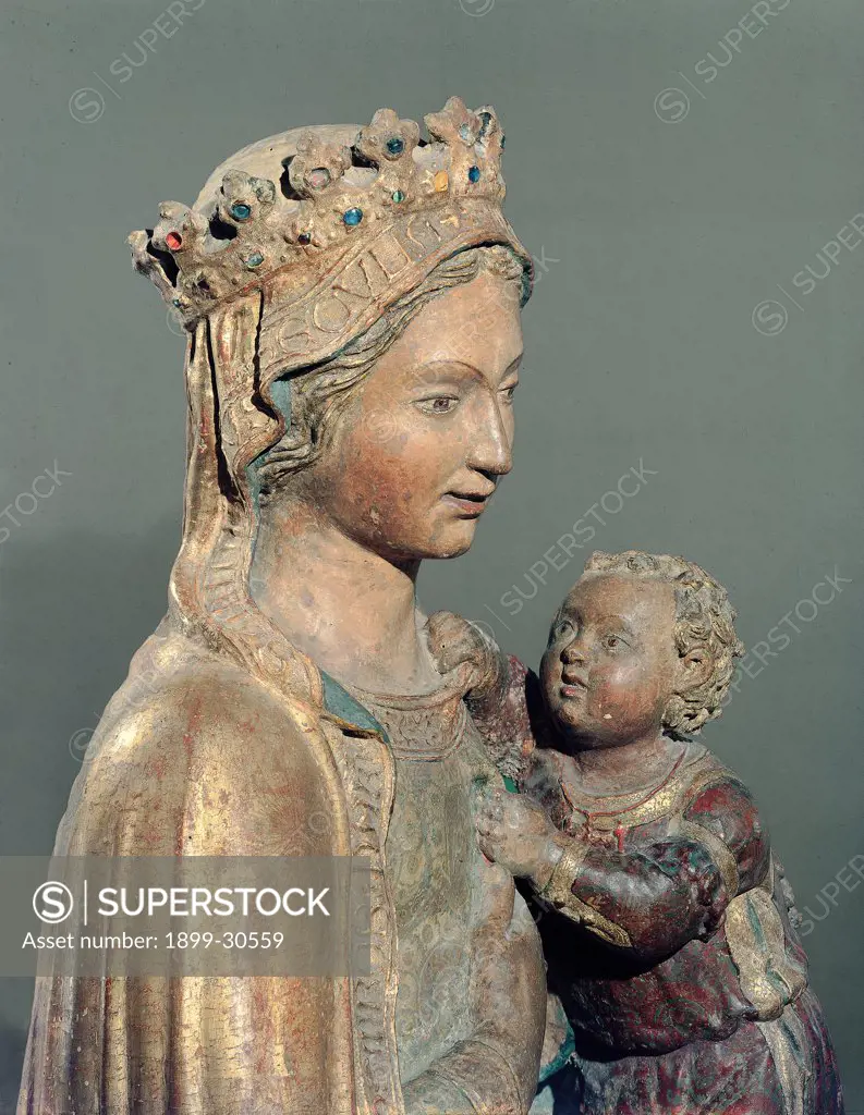 Madonna with Child, by Di Nanni Mattia, 15th Century, wood, freestanding and painted. Italy, Tuscany, Siena, Sant'Agostino church. Detail. Madonna Mary dress: robe: garment veil crown pensive face holding Baby: Child Jesus red dress edge gold attribute of kingship.