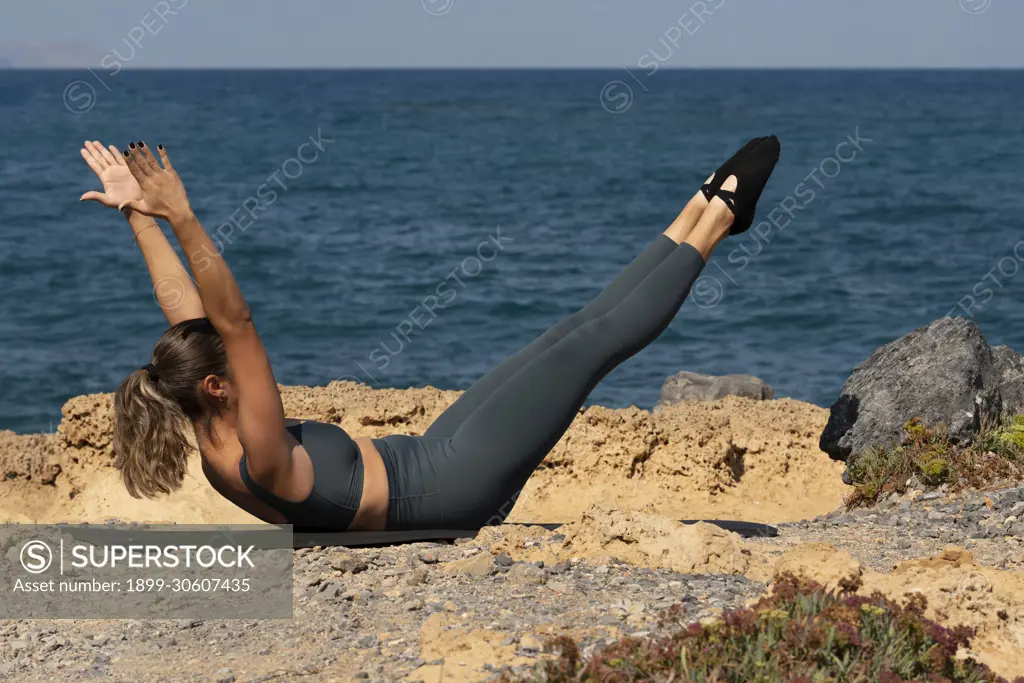 Malia, Crete, Greece, Pilates exercises on the beach in Crete