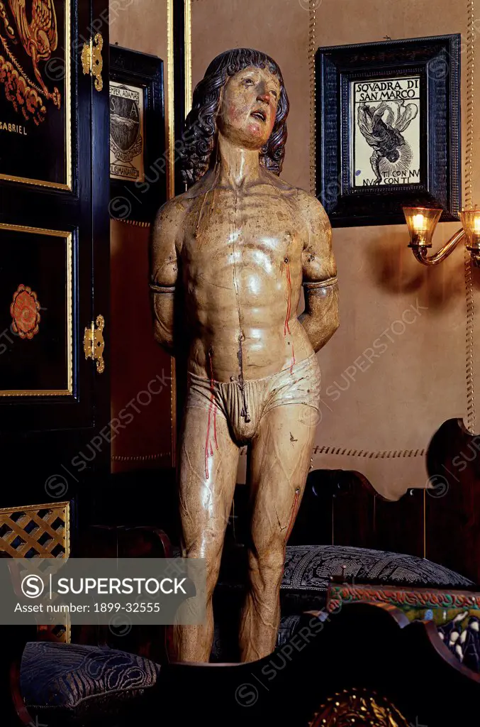 Vittoriale of St Sebastian, by Unknown, 16th Century, wood. Italy, Lombardy, Gardone Riviera, Brescia, The Vittoriale. Whole artwork. Saint man martyrdom St Sebastian young man blood wounds arrows.