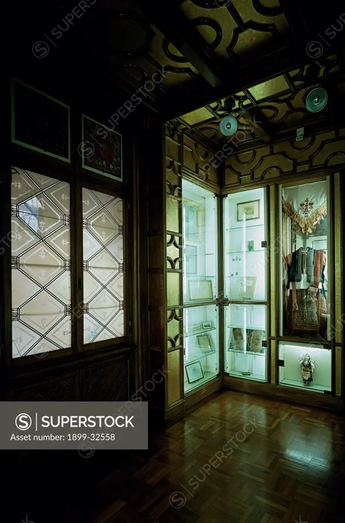 Vittoriale of interior, by Unknown, 20th Century, Unknow. Italy, Lombardy, Gardone Riviera, Brescia, The Vittoriale. View interior glass windows glass cases objects.