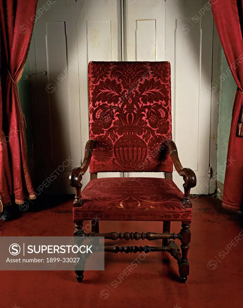 Armchair, by Ligurian Work, 17th Century, velvet. Italy, Liguria, Genoa, Palazzo Spinola National Gallery. Whole artwork. Armchair red amphora leaves lustrous fabric flowers.