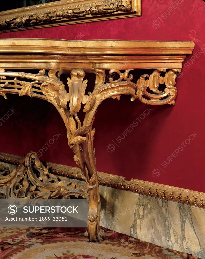 Console Table, by Emilian workmanship, 18th Century, wood carved and gilded, top covered with velvet. Italy, Tuscany, Florence, Palazzo Pitti, Quartiere d'Inverno. Detail. Wall table console gold rinceaux volutes red wall leaves.