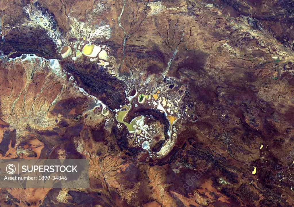 Shoemaker Crater, Australia, True Colour Satellite Image. True colour satellite image of Western Australia's Shoemaker impact structure. Resembling splotches of yellow and green paint, salt-encrusted seasonal lakes dot the floor of the impact structure which was formed about 1.7 billion years ago. It is currently the oldest known impact site in Australia. Image taken on 9 August 1991 using LANDSAT data.