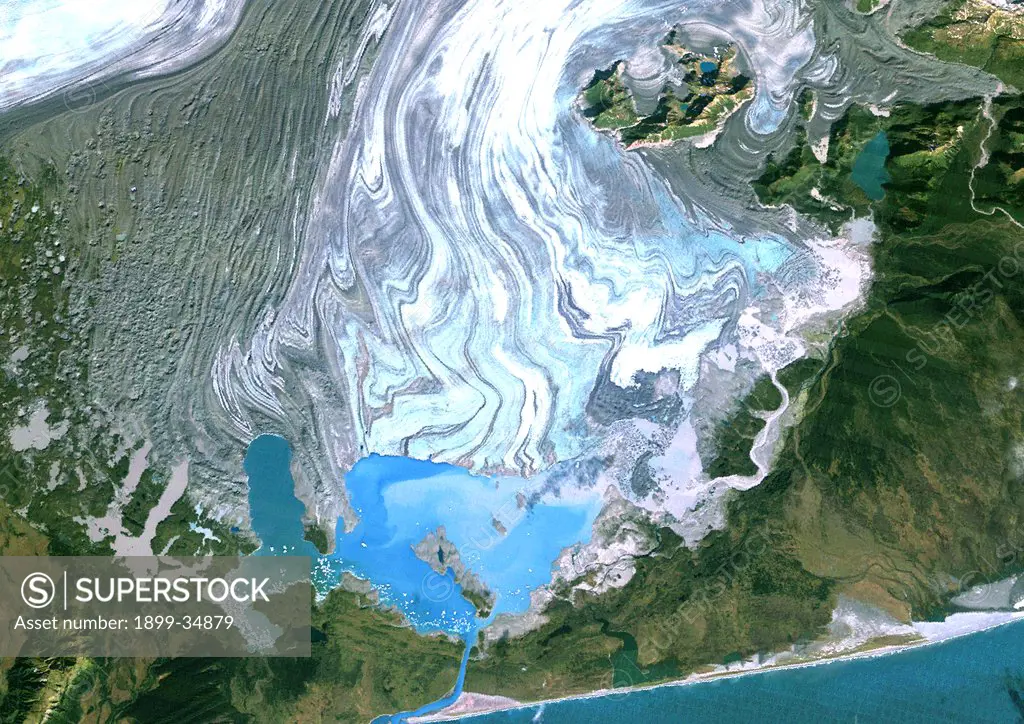 Bering Glacier, Alaska, Usa, True Colour Satellite Image. Satellite image of the Bering Glacier, the largest glacier in North America. It currently terminates in Vitus Lake (South East on the picture), about 10km from the Gulf of Alaska, and flows into the sea through a small outlet. The glacier is bordered by gray moraines. Image taken on 25 September 1986 using LANDSAT data.