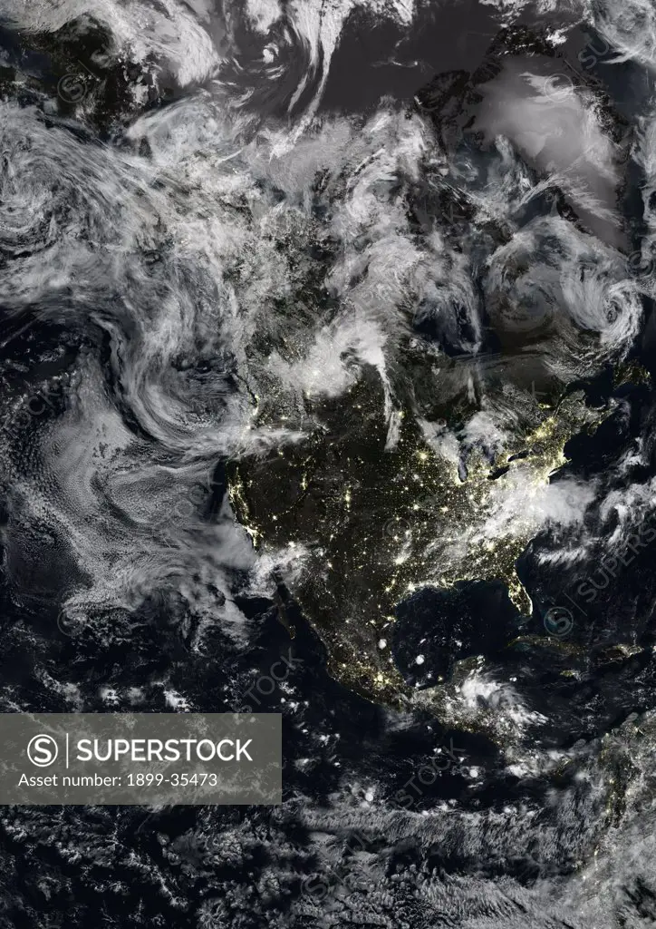 North America At Night With Cloud Coverage, True Colour Satellite Image. True colour satellite image of North America at night with cloud coverage. This image in Lambert Conformal Conic projection was compiled from data acquired by LANDSAT 5 & 7 satellites.