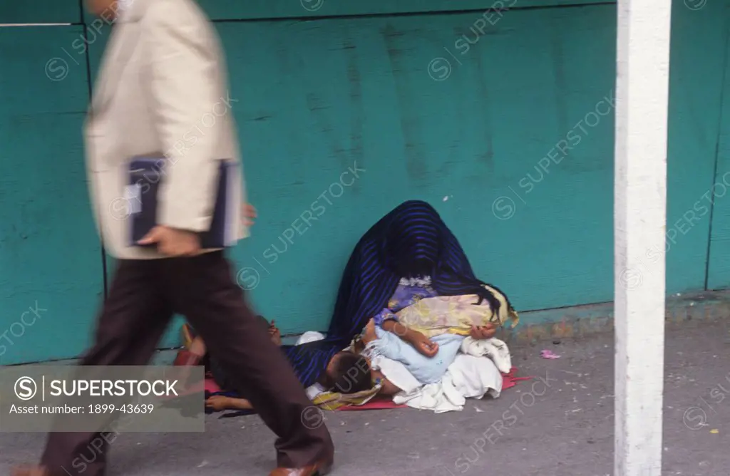BEGGARS, MEXICO CITY. Indian mother with her children begging on the streets. . 
