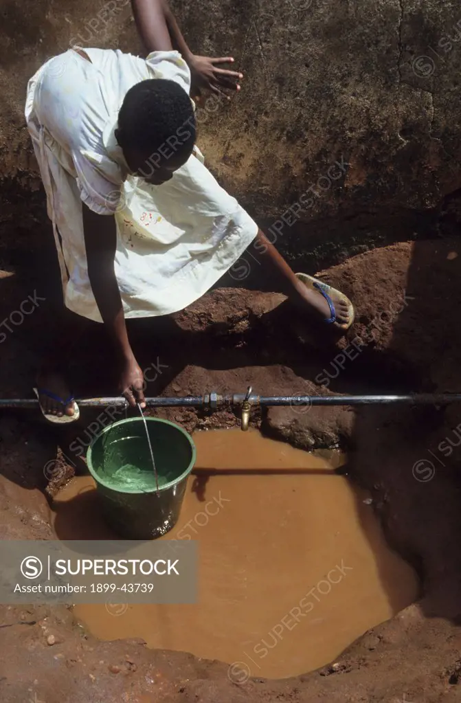 COLLECTING WATER, NIGERIA. From a well. . 