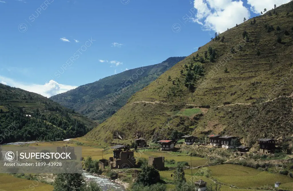 RURAL LANDSCAPE, BHUTAN. WANDIPHODRANG VILLAGE. Most of Bhutan is mountainous. Houses are surrounded by terraced fields. . 