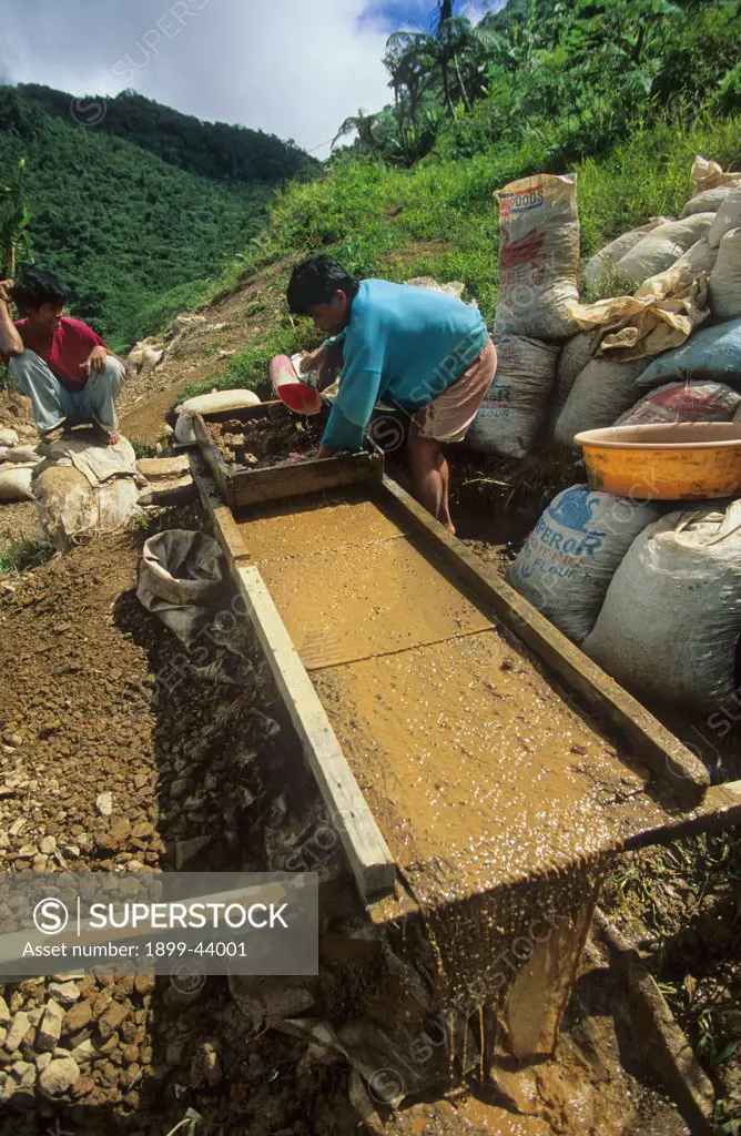 ILLEGAL GOLD MINE, PHILIPPINES. Diwalwal. Panning gold from mining waste. . 