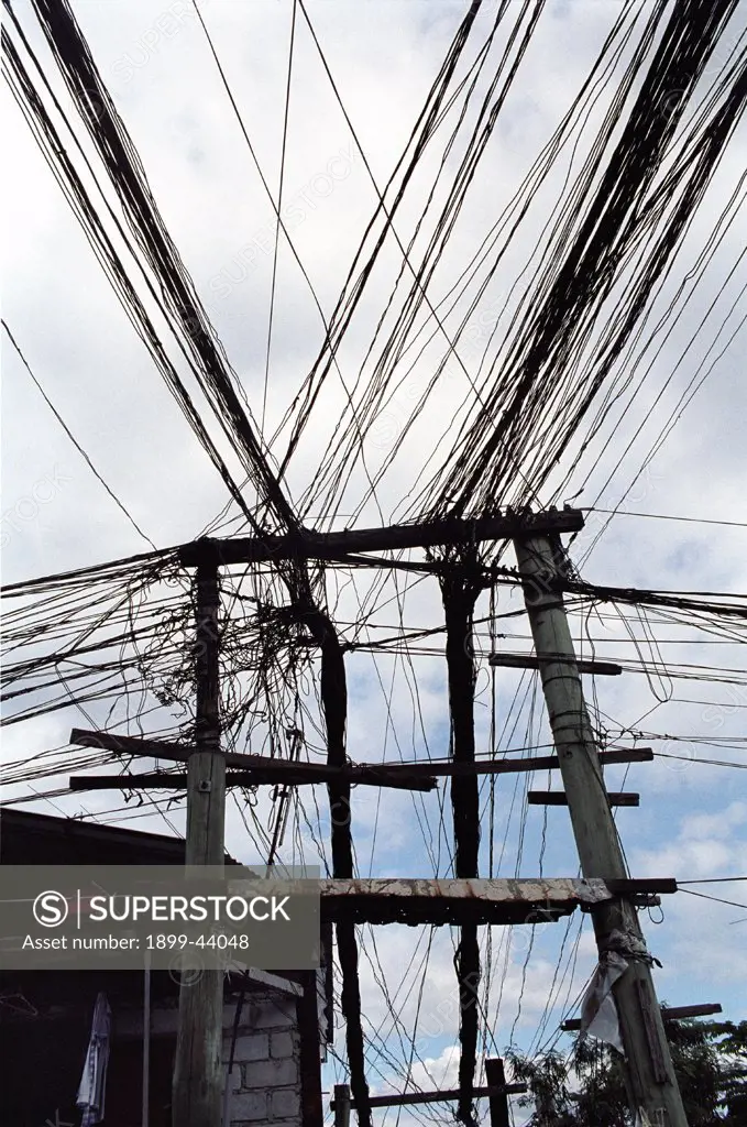 ELECTRICITY, PHILIPPINES. Manila. Electric cables. Householders and shopkeepers make illegal connections to electric cabling. . 