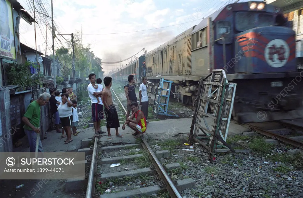 SLUM, PHILIPPINES. Manila. Sucat Railway Community. Over 10,000 families live along this railway track through the city. . There are plans to upgrade the line which would mean the community would have to re-locate. 