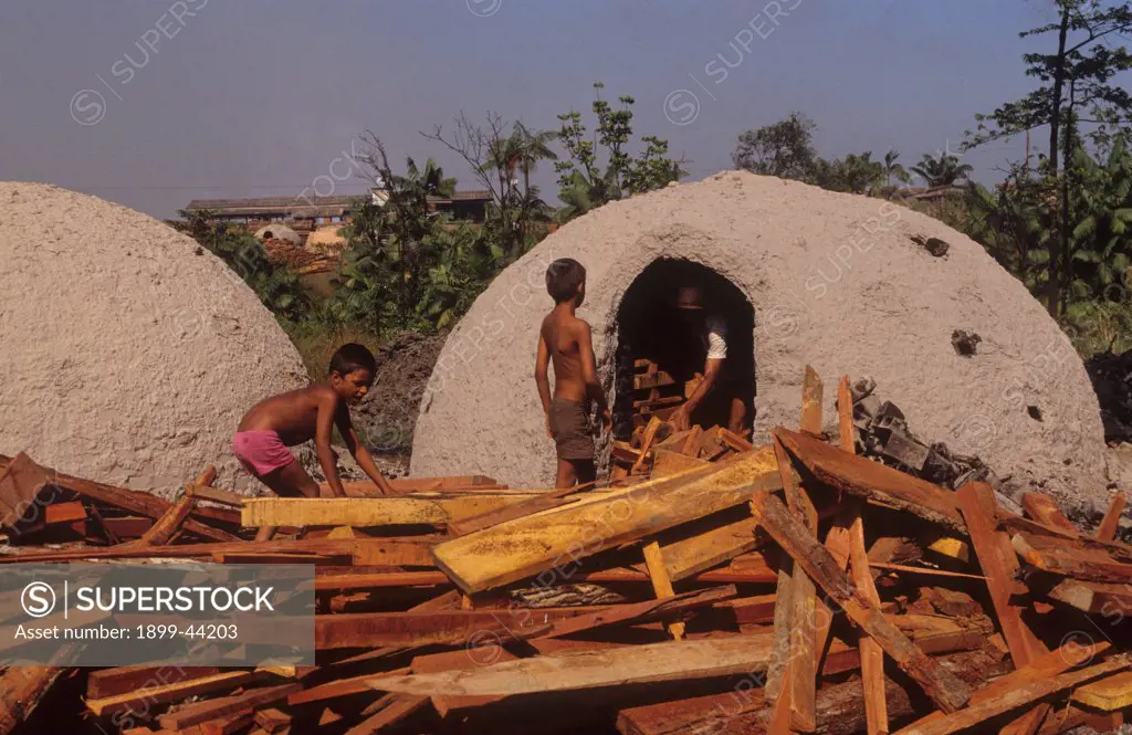 CHILD LABOUR, BRAZIL. Amazon, Paragominas. Charcoal kilns. Charcoal is also produced by the sawmills using mahogany offcuts. . Children work 12 hour shifts about 2 dollars and 50 cents a week. Much of the charcoal is used to smelt iron ore. 