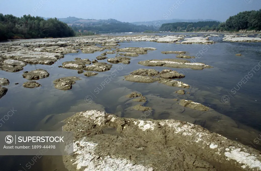 ITALY. River Po, vicinity Casale. Water taken from the Po for intensive farming has increased to 18 billion cubic metres a year. . In many places, the river is almost emptied, exposing the rocky river bed. 