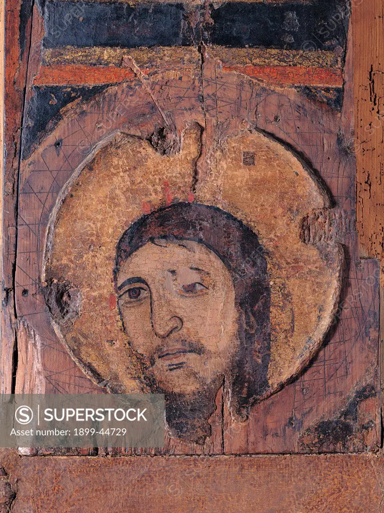Crucifix, by Unknown artist, 12th Century, oil on panel. Italy: Lazio: Latina: Fondi: San Pietro Apostolo church. Detail. Face Jesus Christ halo/aureole