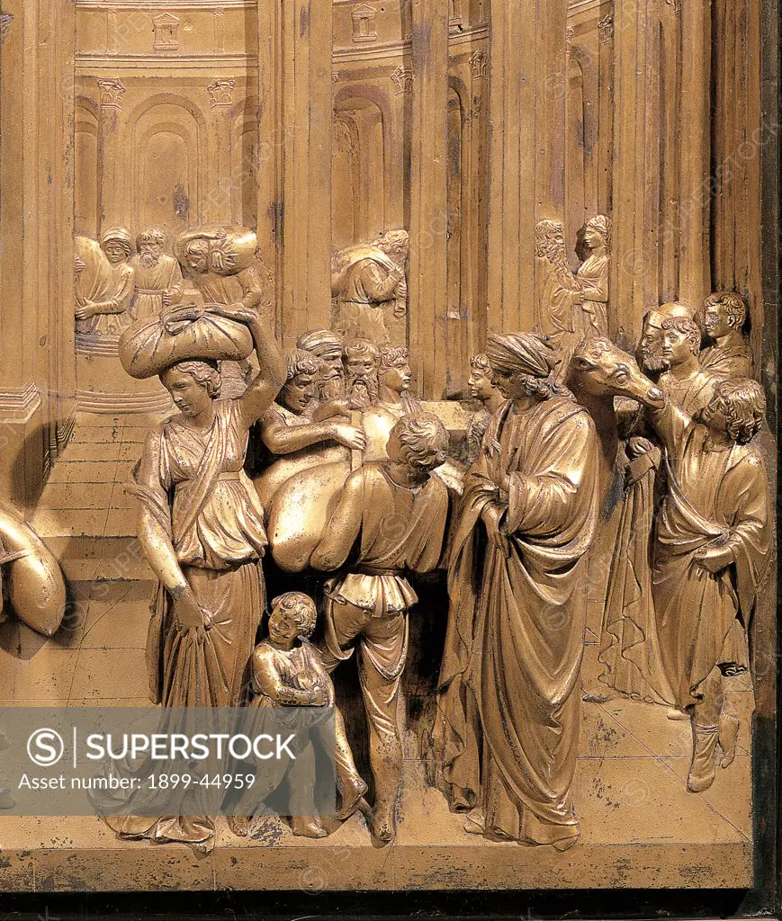 The Story of Joseph, by Ghiberti Lorenzo, 1425 - 1452, 15th Century, casting bronze, chased and gilded. Italy: Tuscany: Florence: Opera di Santa Maria del Fiore Museum. Detail. Panel gold decoration woman men child merchants brothers Joseph bags packs goods sale
