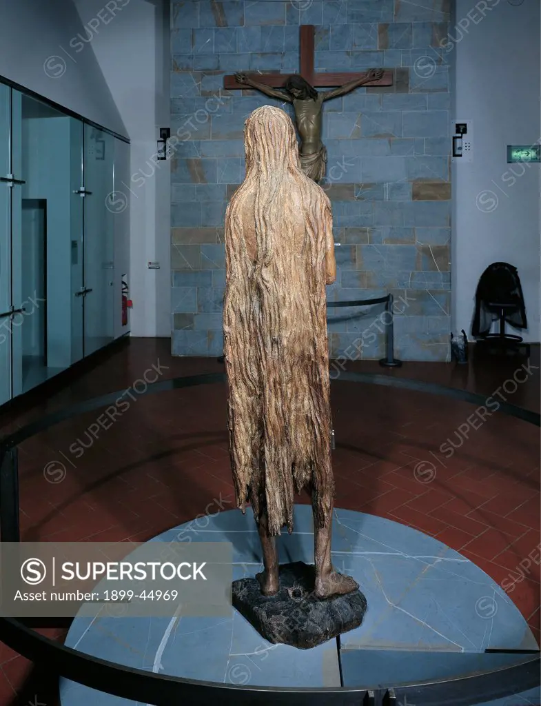 St Mary Magdalene, by Donato di Niccolo di Betto Bardi known as Donatello, 1453 - 1455, 15th Century, wood carved, gilded and painted. Italy: Tuscany: Florence: Opera di Santa Maria del Fiore Museum. Whole artwork. From behind back woman Mary Magdalene statue long hair
