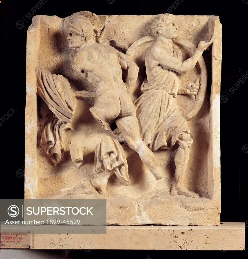 Metope, by Unknown artist, 3rd Century ,, . Italy: Puglia: Taranto: Taranto: National Archaeological Museum. Whole artwork. Two warriors right naked helmet left tunic/habit shield Hellenistic stylistic features volumetry proportions pathos intersecting planes