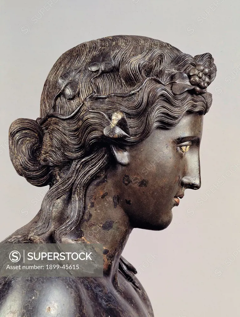 Statue of Dionysus, by Unknown artist, 1st Century, bronze, lost wax casting. Italy: Lazio: Rome: Palazzo Massimo alle Terme: Sala VII - inv. 1060. Detail of the face, profile. Statue of Dionysus recovered into the Tiber bed during the foundation works of a Garibaldi bridge pier (1885). The restoration in 1984-1985 has removed the 19C stucco works