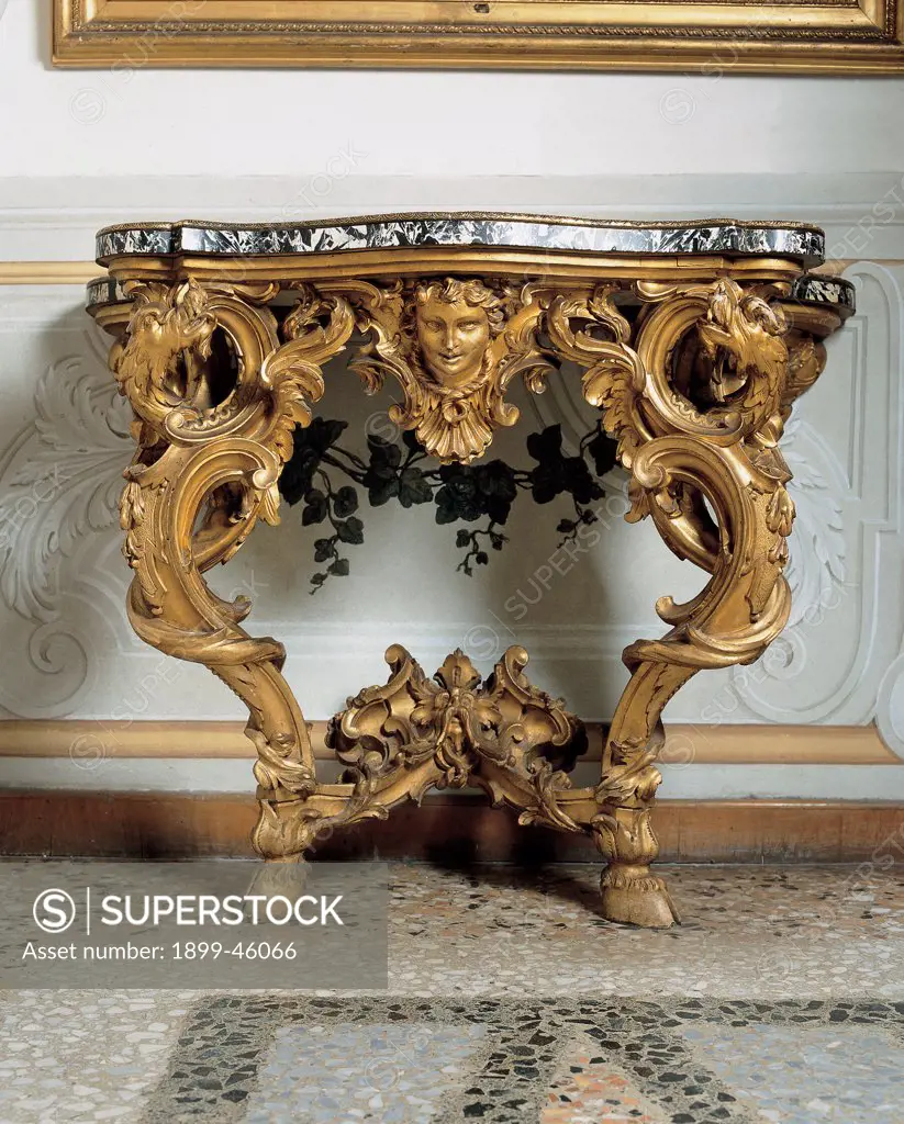 Wall table, by Rome workmanship, 18th Century, wood carved and gilded, top veneered and Aquitaine marble. Italy: Lazio: Rome: National Gallery of Ancient Art: Galleria Nazionale d'Arte Antica. Detail. Console wall table gold marble red racemes volutes decoration