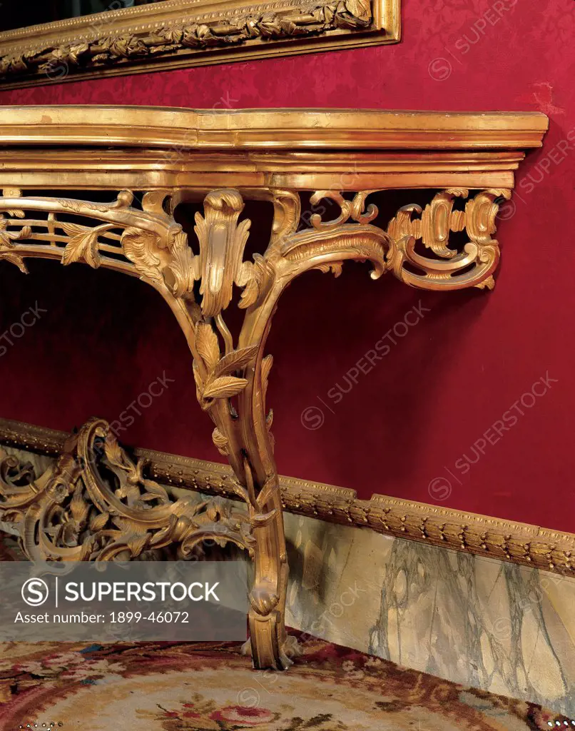 Console Table, by Emilian workmanship, 18th Century, wood carved and gilded, top covered with velvet. Italy: Tuscany: Florence: Palazzo Pitti: Quartiere d'Inverno Salotto Rosso. Detail. Console table console gold riceaux spiral scrolls red wall leaves
