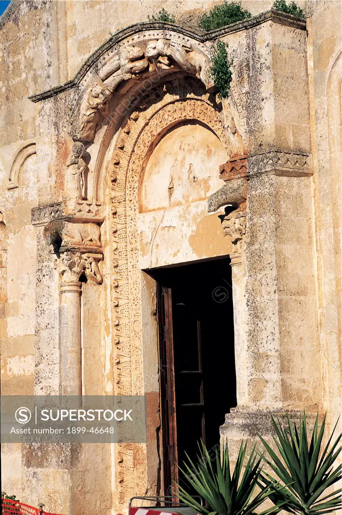 Church of Santa Maria di Cerrate near Lecce, by Unknown artist, 12th Century, tufa. Italy: Puglia: Lecce: Lecce: Santa Maria di Cerrate Church. Detail. Exterior Church of Santa Maria di Cerrate Lecce facade doorway carved cornice columns plinth capital piglet archivolt high relief stories of the Virgin Mary Madonna