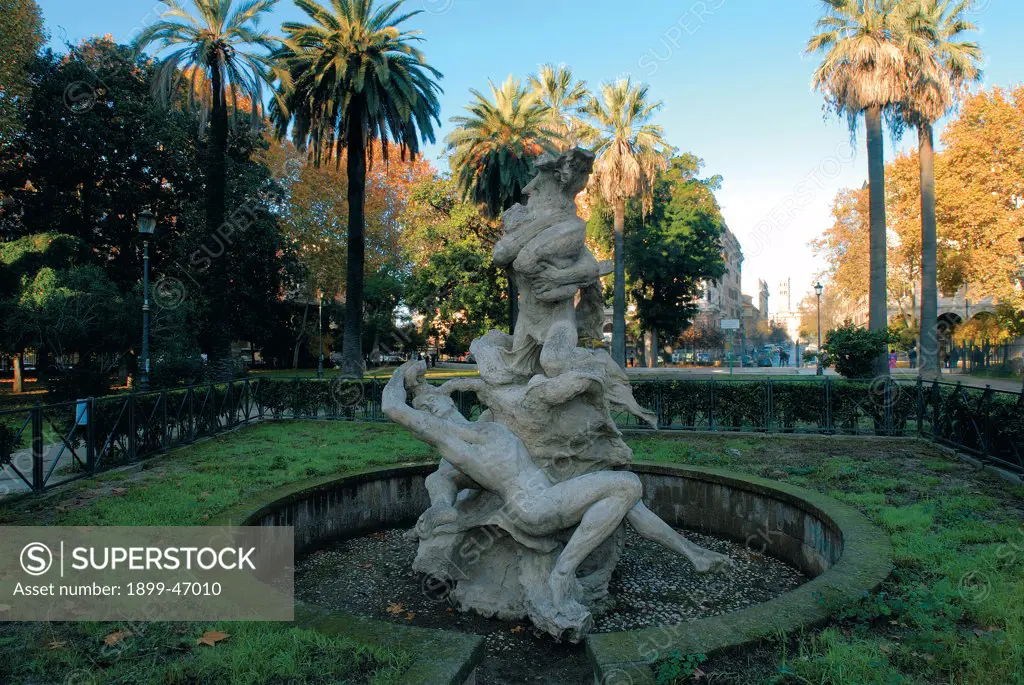 Fountain in Piazza Vittorio Emanuele II, Rome, by Rutelli Mario, 1911, . Italy: Lazio: Rome: Piazza Vittorio Emanuele II. Piazza Vittorio Emanuele II Rome gardens palm-trees fountain circular basin sculptural group tritons dolphin octopus male nude