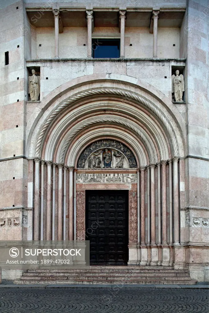 Parma Cathedral, Baptistery, by Antelami Benedetto, 1196, 12th Century, . Italy: Emilia Romagna: Parma: Baptistery. Exterior baptistery doorway slender columns angels tympanum bas-reliefs niches