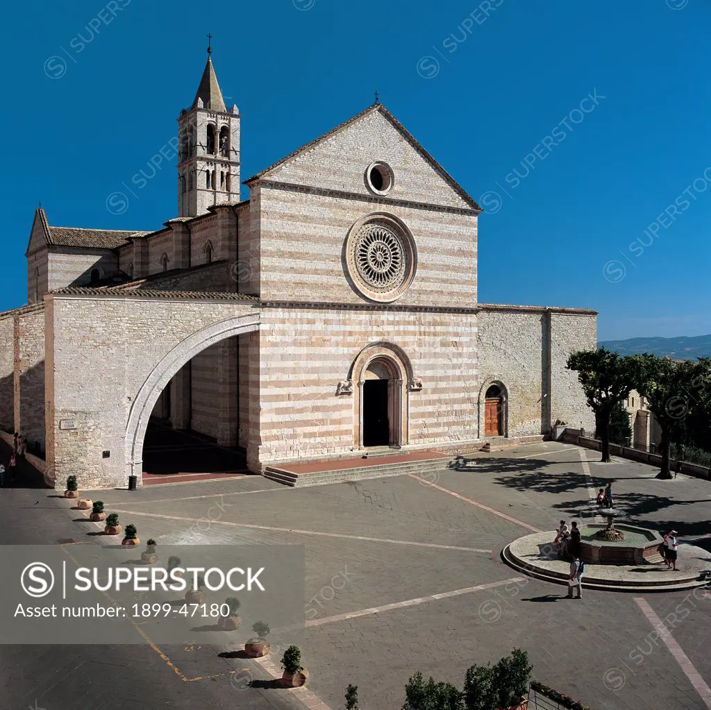 Basilica of Santa Chiara in Assisi, by Unknown artist, 1257, 13th Century, . Italy: Umbria: Perugia: Santa Chiara Basilica. View Assisi church basilica of Santa Chiara bell tower square facade gable roof rose window rampant arch doorway