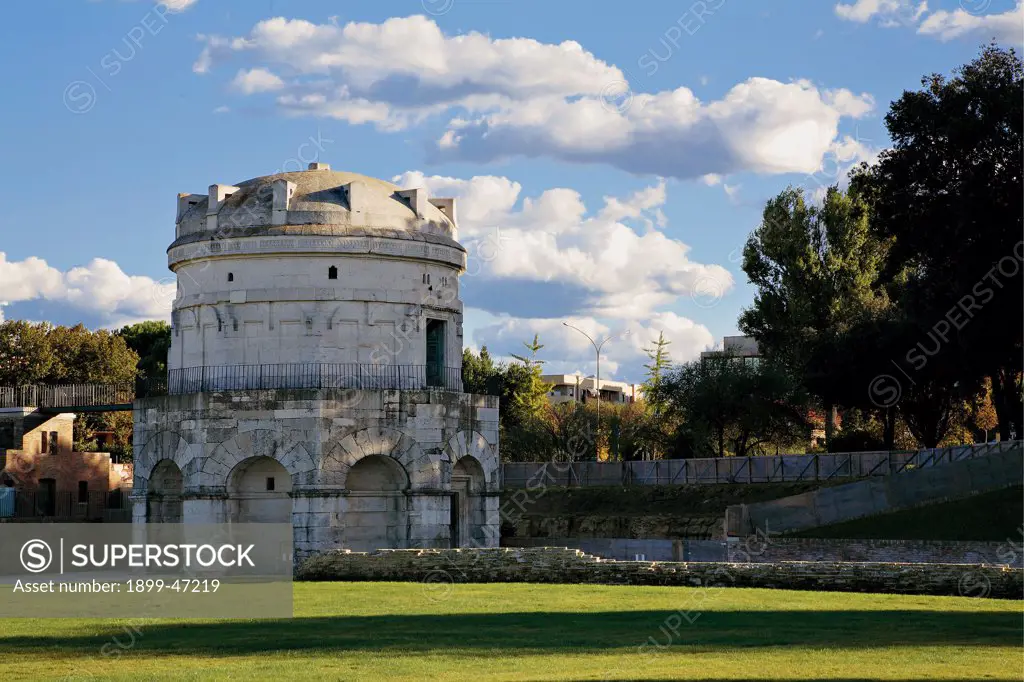 Mausoleum of Theodoric in Ravenna, by Unknown artist, 520, 6th Century, Istrian stone. Italy: Emilia Romagna: Ravenna: Theodoric Mausoleum. Whole artwork. Exterior tomb mausoleum of Theodoric ashlars/quoins white stone gray central decagonal circular plan double order/tier blind round arches second tier entrance pincer-shaped cornice monolithic lowered dome meadow/lawn