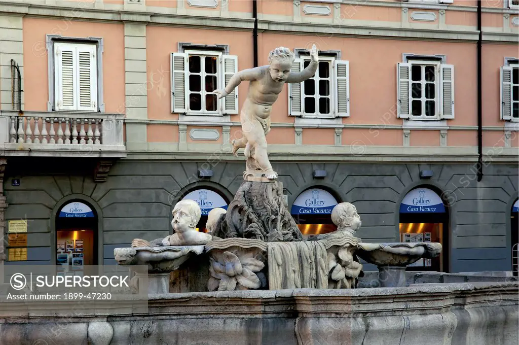 Fountain of Giovanin (Young John), by Mazzoleni Giovan Battista, 1753, 18th Century, . Italy: Friuli Venezia Giulia: Trieste: Piazza Ponterosso: fontana del Giovanin. Detail. Fountain mixtilinear basin putti/cherubs cupid water
