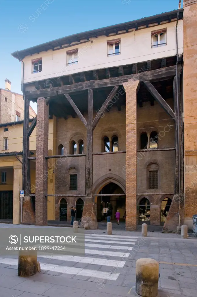 Casa Isolani, by Unknown artist, 13th Century, . Italy: Emilia Romagna: Bologna: strada nuova. Front view street road facade 13C civic building high porch/portico oak beams supporting third floor of house entrance doorway pointed arch two-light windows