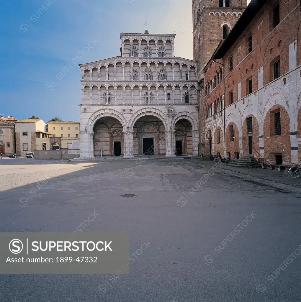 San Martino, by Unknown artist, 1060, 11th Century, . Italy: Tuscany: Lucca: San Martino cathedral: Duomo. Detail. Facade. San Martino Cathedral Lucca porch/portico arches small arches small loggia small columns doorways lunettes bas-reliefs two-color round arches marble white green