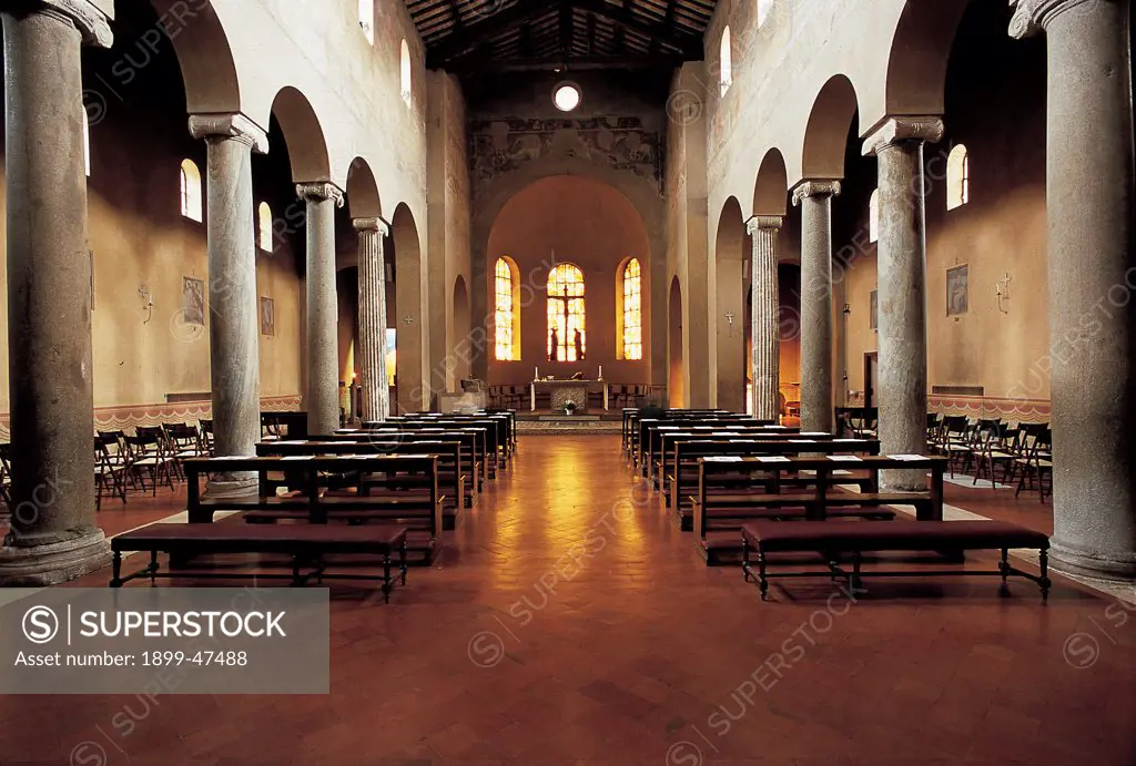 Church of San Giovanni a Porta Latina, by Unknown, 5th Century, Unknow. Italy, Lazio, Rome, San Giovanni a Porta Latina Church. View of interior nave side-aisles ceiling wooden tie-beams trusses marble columns Ionic capitals pews seats altar apse windows light fresco fragments.