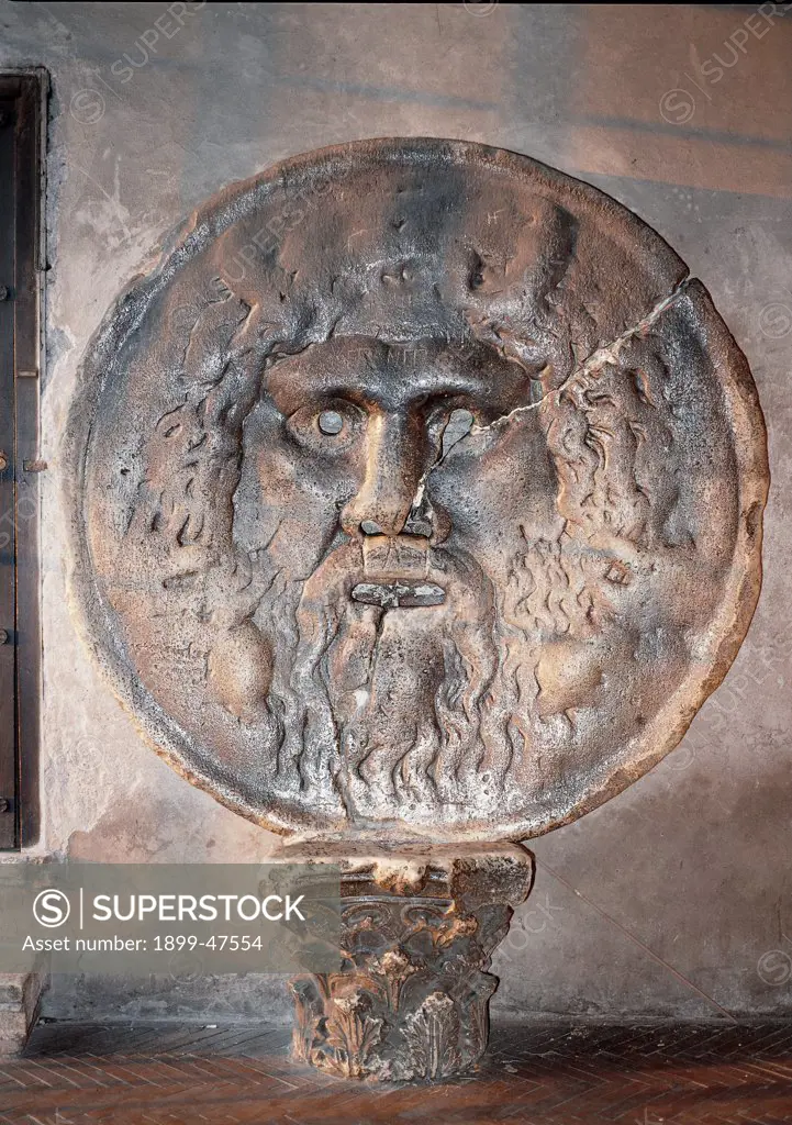 Mouth of Truth, by Unknown, 4th Century, pavonazzo marble. Italy, Lazio, Rome, Santa Maria in Cosmedin church, Porch of the church. Whole artwork. Mouth of Truth sewer cover personification river divinity beard mouth hair Corinthian roman capital caulicoli: small stems: spiral capital.