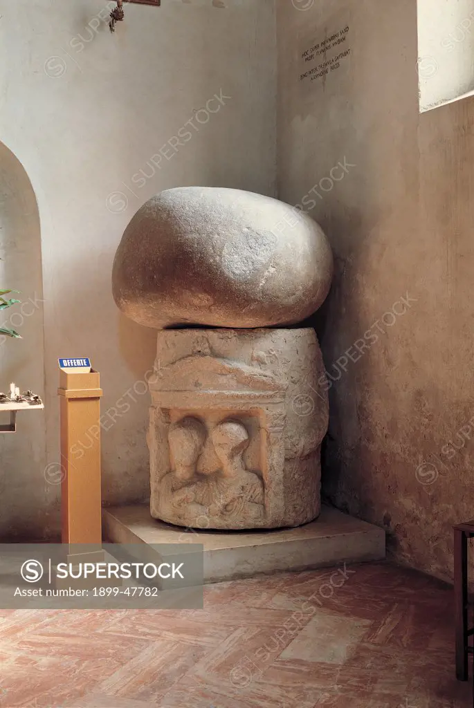 Rock of St Zeno (seat), by Unknown, 1st Century, brick. Italy, Veneto, Verona, Oratory of the San Zeno Church. Whole artwork. Rock of San Zeno sculpture couple man woman rock superimposed decoration arch.